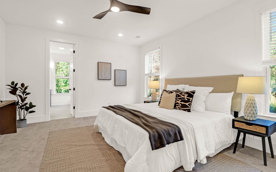 Staged bedroom with modern neutral decor, natural light, and cozy ambiance