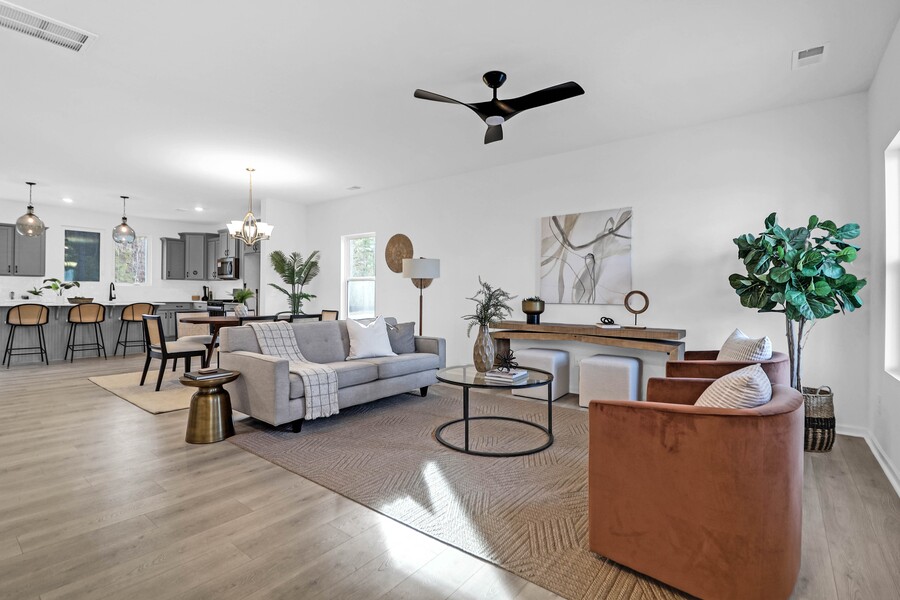 Professionally staged open concept living room with modern furniture and neutral decor